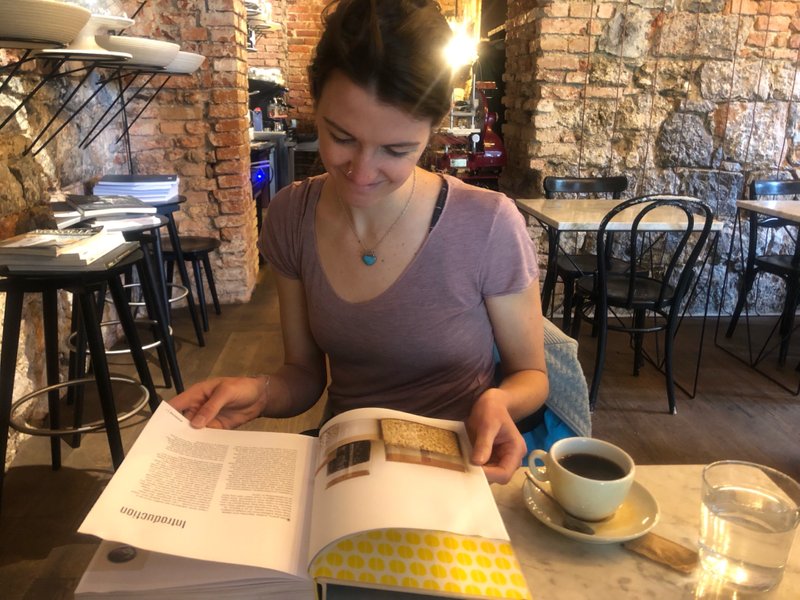 Sheila enjoying a cookbook at EK Bistro